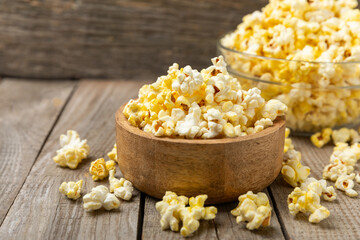 Salty popcorn on bright color background. Cinema and entertainment concept. Movie night with popcorn. Delicious appetizer, snack.Space for text, copy space. Banner