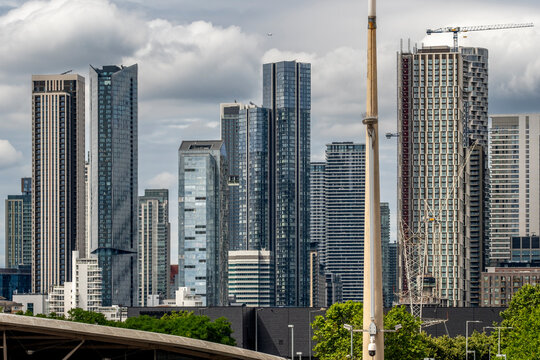 An impressive collection of sleek glass skyscrapers reflecting the sky, showcasing contemporary urban design and architecture which emphasizes innovation and modern living in London UK