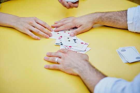 Couple playing cards at table