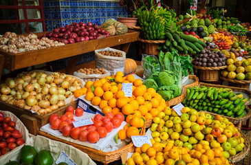 Colorful display of fresh fruits and vegetables at Mercado dos Lavradores in Funchal, Madeira, Portugal.