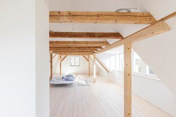 Spacious attic under construction with wooden beams