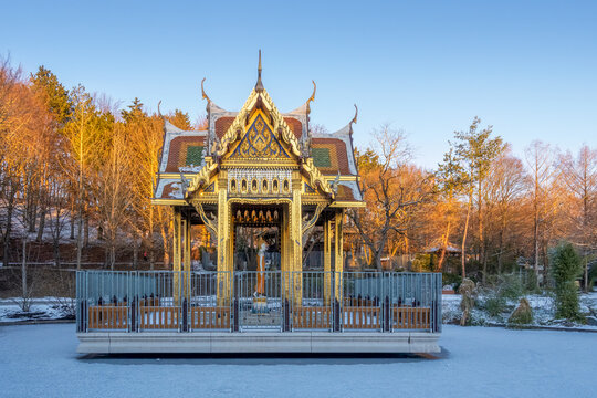 Thai Sala with Buddha statue in snowy Westpark, Munich, Germany