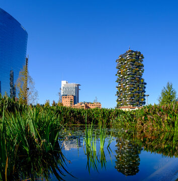 Bosco Verticale in Milan with green towers and reflection in a pond