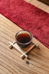An elegant tea presentation on a wooden table with striking red accents enhancing its appeal