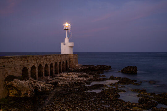Lighthouse at the harbor in Otranto, Apulia during twilight