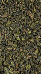 An Intimate CloseUp of Dried Green Tea Leaves Showcasing Their Unique and Intricate Texture