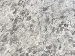 Close up photo of natural grey and white granite slab with random washed texture mainly used for wall finishes for floor finishes. Luxurious feel. seamless texture.