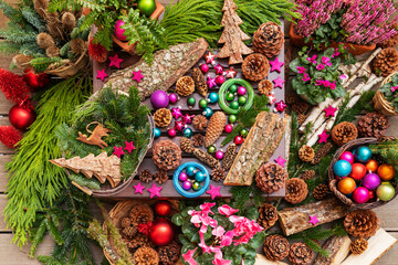 Christmas decorations with fir tree, flowers, and festive items.