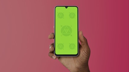 Black African-American young male using smartphone with a blank green screen. Mobile app video mockup. Vertical phone orientation
