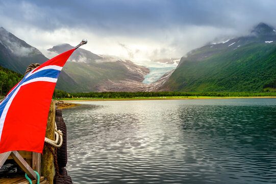 Scenic view of Holandsfjord with Norwegian flag at ferry terminal in Holandsvik, Norway