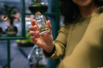 Pregnant woman holding a small bottle at work in London