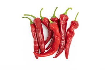 A pile of red hot chili peppers on a white background