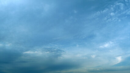 Obraz premium Flying moving white clouds in a blue sky. Blue sky background with many layers tiny clouds. Timelapse.