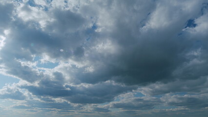 Stratus with stratocumulus clouds flying slowly on beautiful blue sky horizon background. Timelapse.