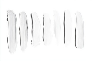 Fototapeta premium A row of white makeup brushes, each with a different length and width