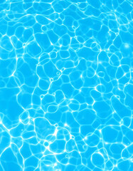 Fresh water background. Bright blue pattern with natural rippled water texture. Clear drinking water. Top view with copy space, photo