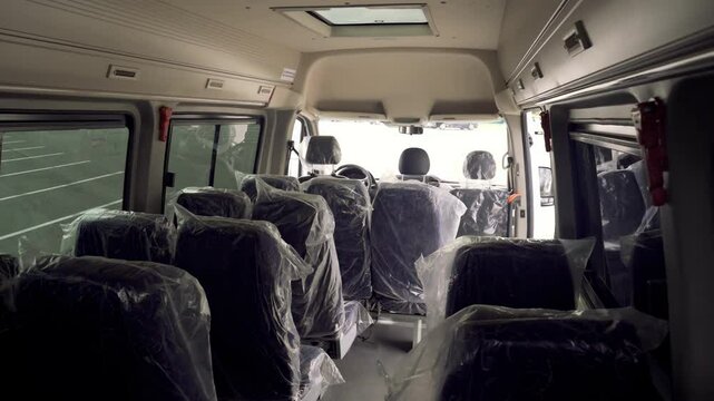 A spacious interior awaits transformation as seats are meticulously wrapped in protective film. This reveals potential for future journeys filled with memorable experiences.