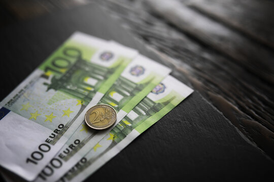 100 euro banknote pack and wood bankground. Currency, financial