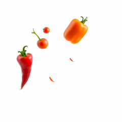 An array of vibrant vegetables, including bell peppers, tomatoes, and leafy greens, captured mid-flight,