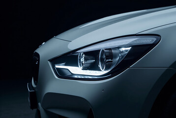 Closeup view of car front headlight showcasing modern design and highend automotive craftsmanship against a dark background Generative AI image 