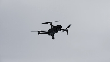 Drone against the sky. Copter in flight.