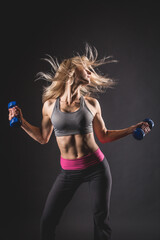 Energetic Woman Lifting Dumbbells in Dynamic Fitness Motion