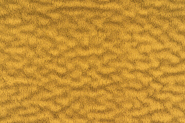 Yellow velvet or velour with short pile fluffy and soft texture background. Close-up detail macro photography top view of yellow color cloth material, colored background texture of fabric for design.