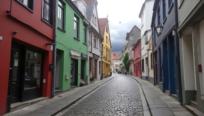 Charming cobblestone street in an old town with colorful buildings and a cloudy sky