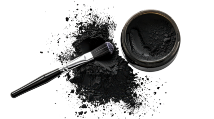 Black cosmetic powder spills from an open jar with a brush laid next to it on a white surface, highlighting makeup artistry tools and materials on transparent background