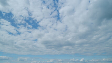 Fototapeta premium Puffy fluffy white clouds. Forming cloud moving with blue sunny, summer skies. Time lapse.