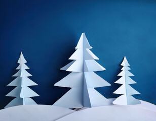 Obraz premium Abstract winter scene with paper trees against a deep blue sky
