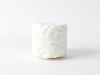 A fluffy white marshmallow standing alone on a white background, confectionery