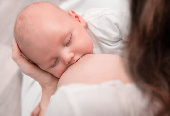 newborn baby eats from mother's breast close-up. breastfeeding a child. Lactation Concept