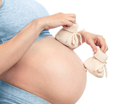 pregnant woman walking baby booties on her belly isolated on white background