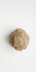 Fototapeta premium A single, textured rock stone placed on a plain white background, material