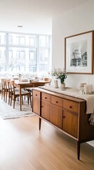 Fototapeta premium Charming oak sideboard featuring two drawers and one door, accompanied by a wooden chair draped in a beige blanket and a small plant on top