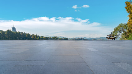 Tranquil Landscape View with Pavilion and Distant Pagoda Under Bright Blue Sky
