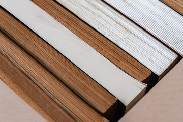 A stack of old books stored in a cardboard box, background and texture