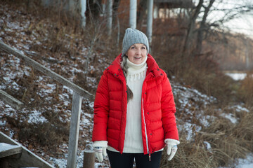 portrait of a cheerful senior woman   in winter nature. Enjoying the little things. Winter Vibes. christmas holiday. copy space