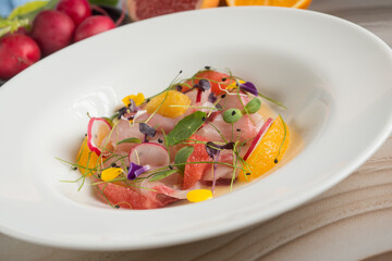 swordfish carpaccio with orange grapefruit radish and flowers
