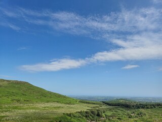 Mountain Landscape with Cumulus Clouds and Grassland