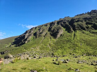 Mountain Landscape with Grass and Clouds under the Sky