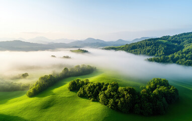 Aerial view of rural area with fog blanketing lush green hills