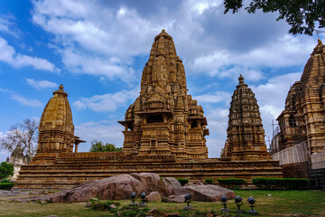 Fototapeta premium India. Madhya Pradesh state. The Khajuraho Group of Monuments are a group of Hindu and Jain temples. Lakshmana temple under a blue sky
