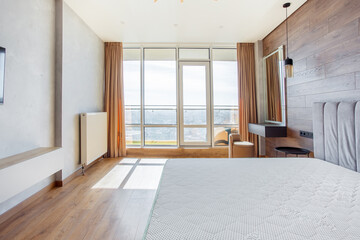 Fototapeta premium large modern bedroom bed with headboard warm wooden laminate on wall