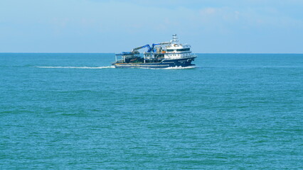 Fishing Vessel Goes To Sea To Catch Fish. Ship Floats On Sea Surface Leaving Path Of Sea Foam Water. Still. © artifex.orlova