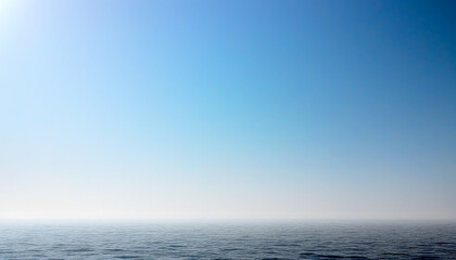 Obraz premium Expansive horizon meeting serene waters under a clear blue sky