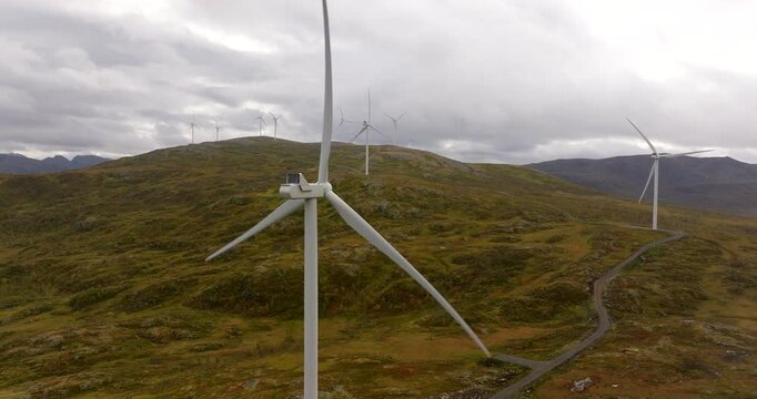Sortland Norway wind farm atop mountains with rotating wind turbines, aerial