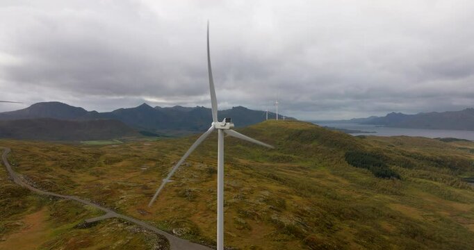 Turning wind turbines of wind park in alpine landscape of Norway, aerial
