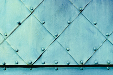 Industrial steel rough background. Pale blue textured metal surface of aged carved metal plates...